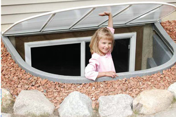 Galvanized egress window well installed against a home's foundation