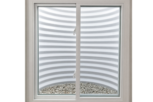 New white vinyl basement replacement window installed with clean gravel base